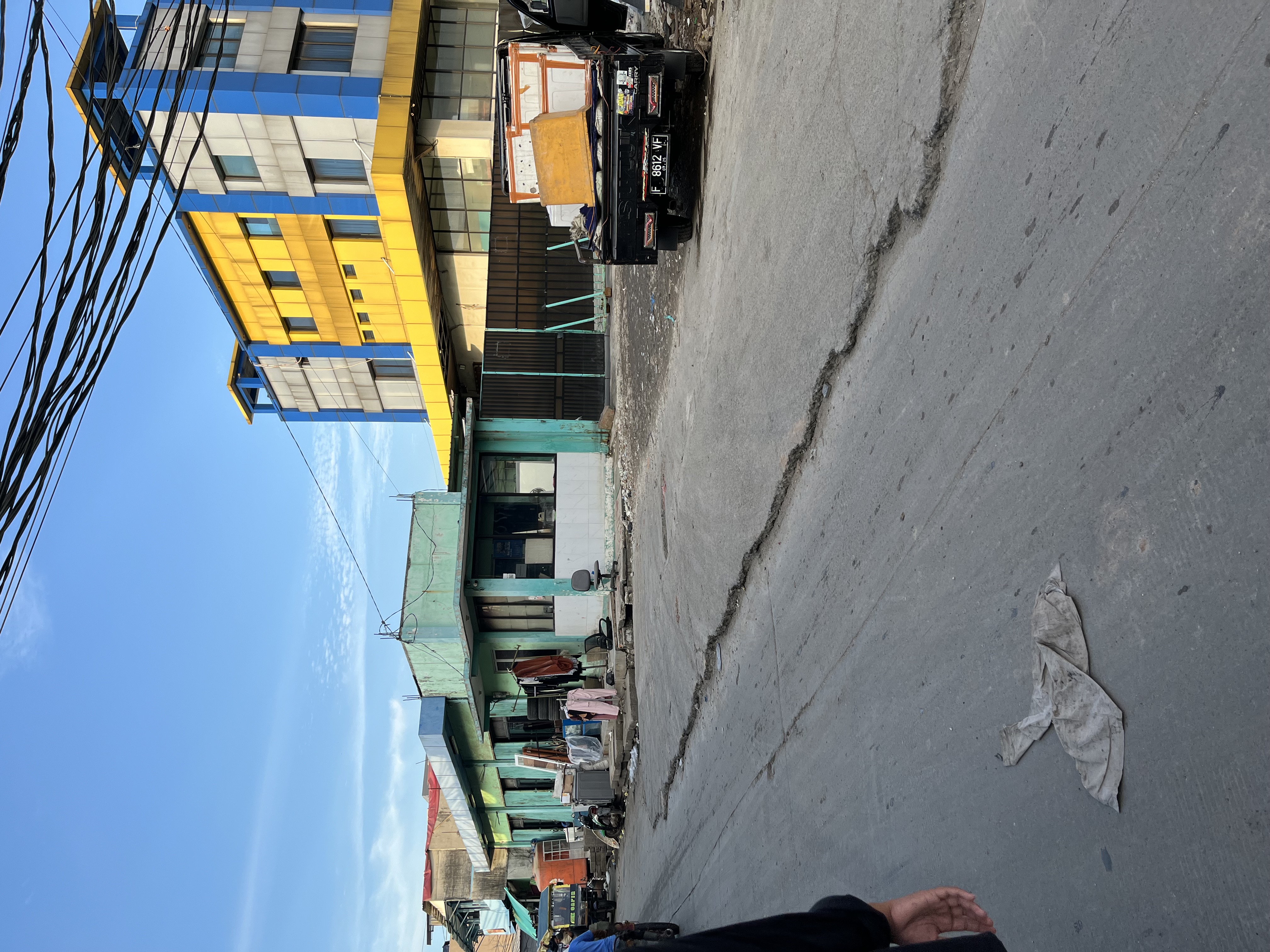 Children swimming at Curug Eceng, a drainage overflow point in Muara Angke that youth have renamed as a waterfall play spot